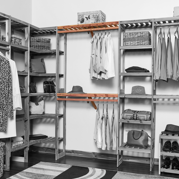 Organized closet featuring a double hanging kit with red cedar shelves, hanging rods, and J-hooks, surrounded by various garments and storage accessories.