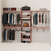 A closet wall kit made of aromatic red cedar, featuring multiple shelves and hanging rods within an organized closet space.