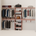 A closet wall kit made of aromatic red cedar, featuring multiple shelves and hanging rods within an organized closet space.