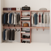 A closet wall kit made of aromatic red cedar, featuring multiple shelves and hanging rods within an organized closet space.