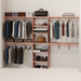 A closet wall kit made of aromatic red cedar, featuring multiple shelves and hanging rods within an organized closet space.