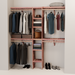 A closet wall kit made of aromatic red cedar, featuring multiple shelves and hanging rods within an organized closet space.