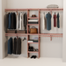 A closet wall kit made of aromatic red cedar, featuring multiple shelves and hanging rods within an organized closet space.