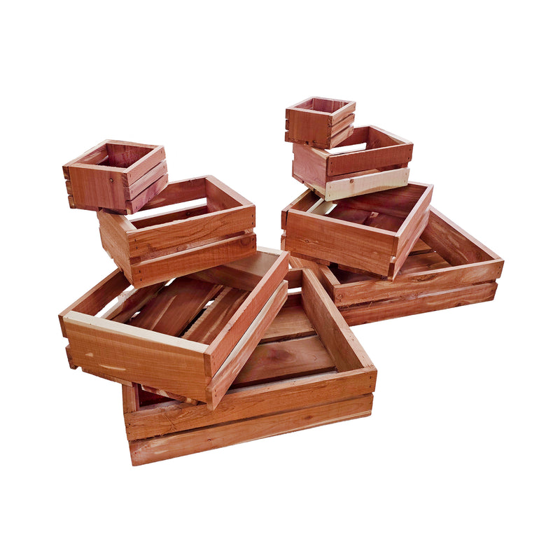 Set of wooden cedar crates of various sizes on a white background