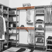 Organized closet featuring a double hanging kit with red cedar shelves, hanging rods, and J-hooks, surrounded by various garments and storage accessories.